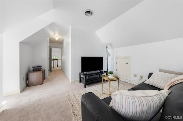 living area featuring vaulted ceiling, light colored carpet, baseboards, and visible vents