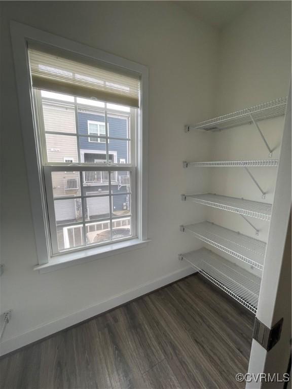 interior space with baseboards and wood finished floors