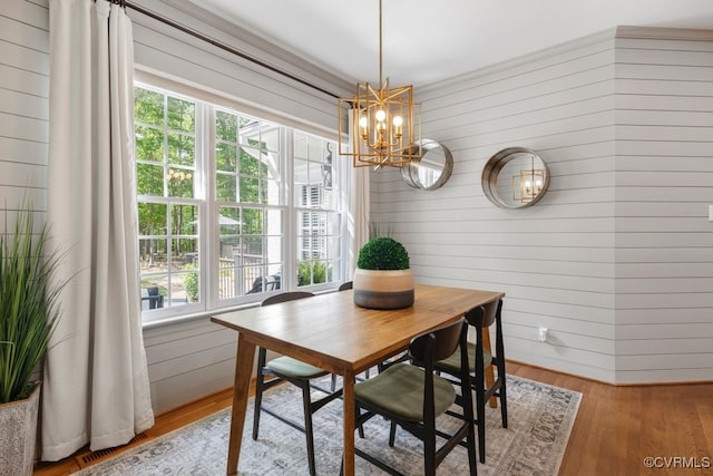 2951 W Maple Grove Ln, Powhatan, VA 23139 - dining space featuring a chandelier, wood walls, plenty of natural light, and wood finished floors