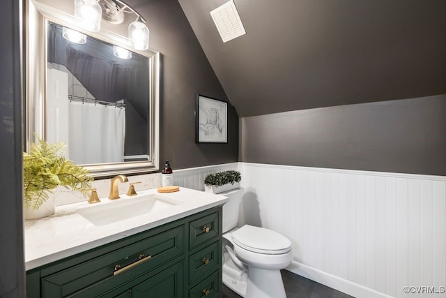 2951 W Maple Grove Ln, Powhatan, VA 23139 - full bathroom featuring lofted ceiling, toilet, vanity, and wainscoting