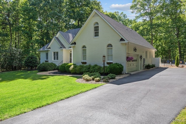 2951 W Maple Grove Ln, Powhatan, VA 23139 - view of front of house featuring roof with shingles, asphalt driveway, an attached garage, and brick siding