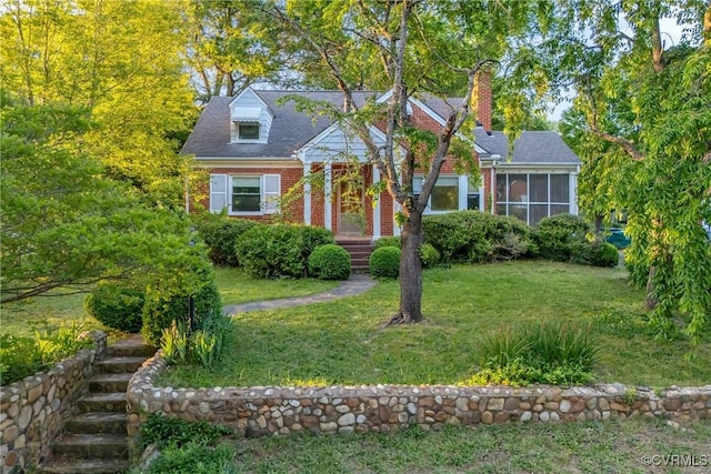 102 Norman Dr, Henrico, VA 23227 - view of front of home featuring brick siding, a chimney, a sunroom, and a front yard