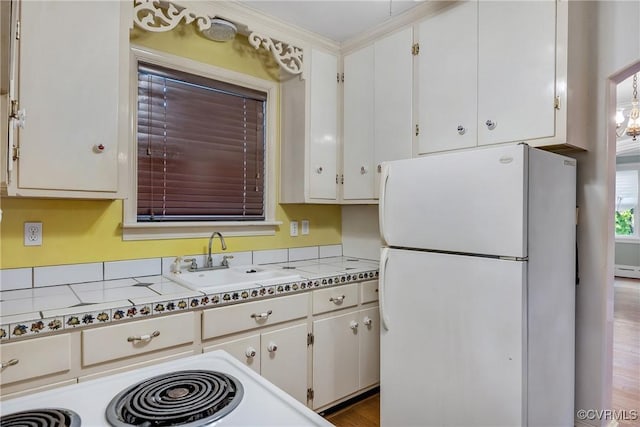 102 Norman Dr, Henrico, VA 23227 - kitchen with a sink, light countertops, white cabinets, and freestanding refrigerator