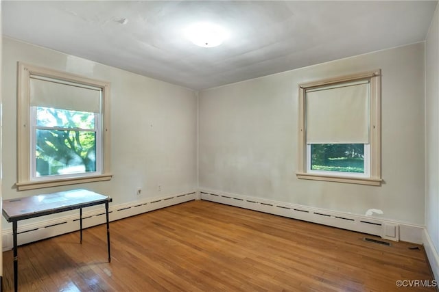 102 Norman Dr, Henrico, VA 23227 - spare room featuring visible vents, a baseboard heating unit, and wood finished floors