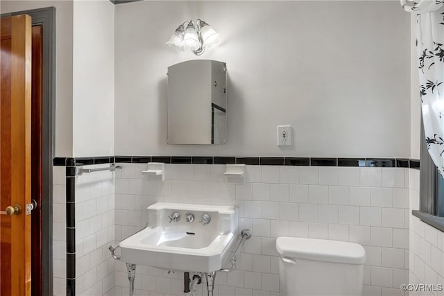 102 Norman Dr, Henrico, VA 23227 - bathroom featuring a sink, tile walls, wainscoting, and toilet