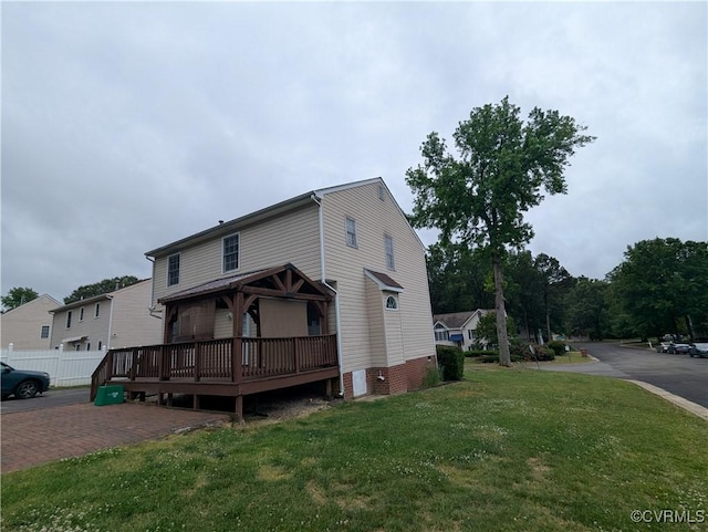 3900 Elmswell Dr, Richmond, VA 23223 - view of side of home featuring a lawn, a wooden deck, and fence