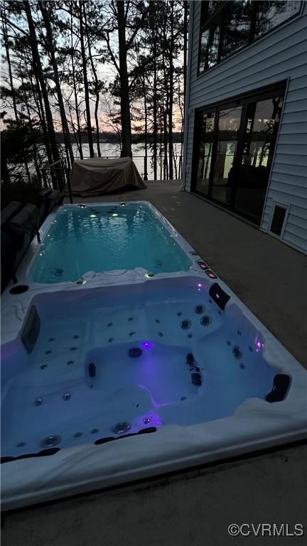 view of pool with an outdoor hot tub