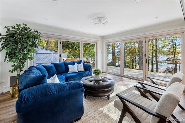sunroom / solarium with a water view and french doors