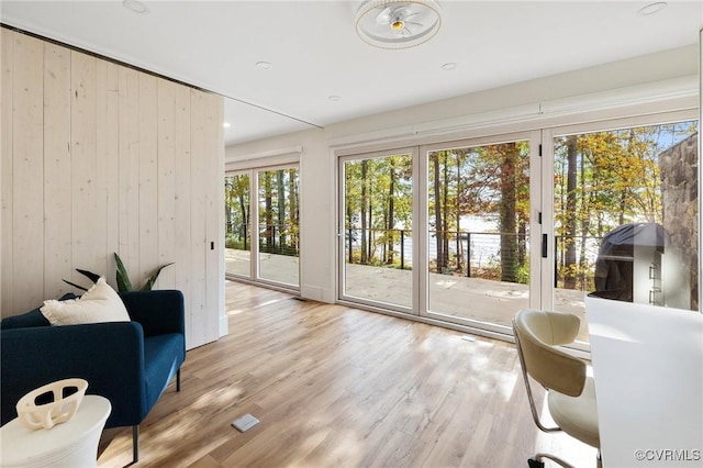 entryway with wooden walls and wood finished floors