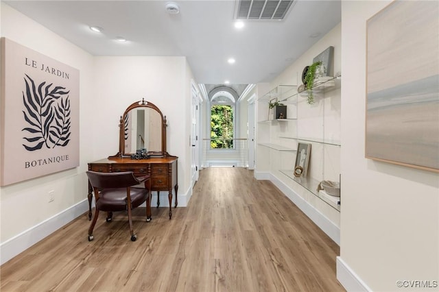 hall featuring baseboards, recessed lighting, wood finished floors, and visible vents
