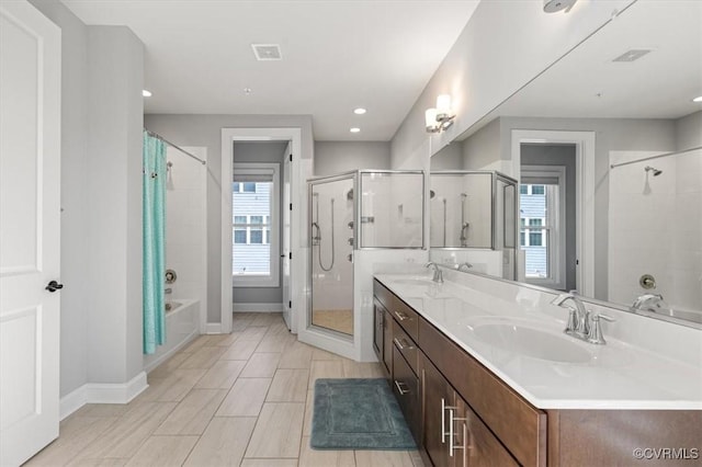 bathroom with a sink, a bathing tub, baseboards, and walk in shower