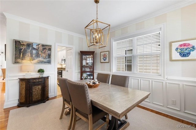4708 Hanover Ave, Richmond, VA 23226 - dining room with an inviting chandelier, light wood-style floors, crown molding, and a decorative wall
