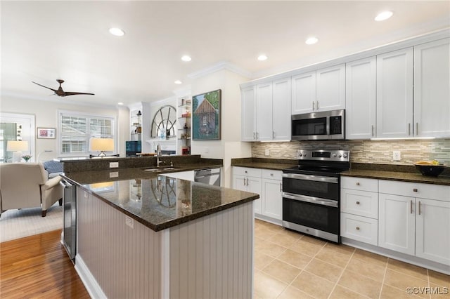4708 Hanover Ave, Richmond, VA 23226 - kitchen with open floor plan, a sink, appliances with stainless steel finishes, and backsplash