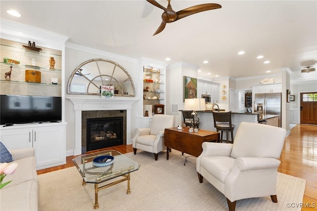 4708 Hanover Ave, Richmond, VA 23226 - living area featuring light wood-style floors, ornamental molding, a glass covered fireplace, and ceiling fan