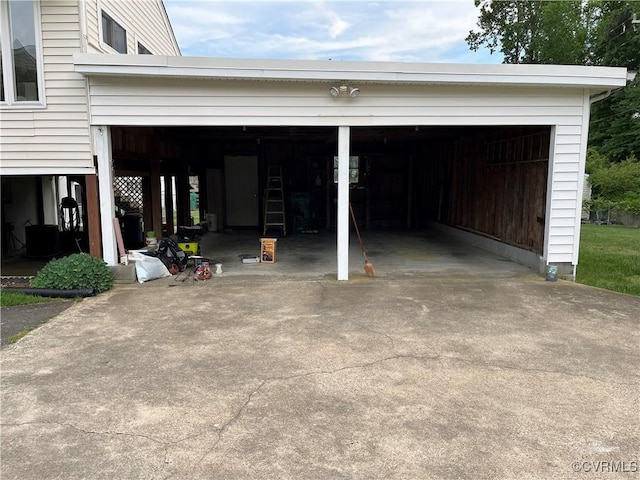 garage featuring concrete driveway