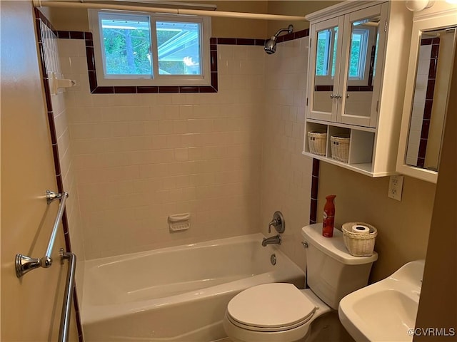 full bathroom featuring a sink, shower / bathing tub combination, and toilet