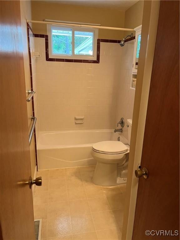 bathroom featuring toilet, shower / washtub combination, and tile patterned flooring