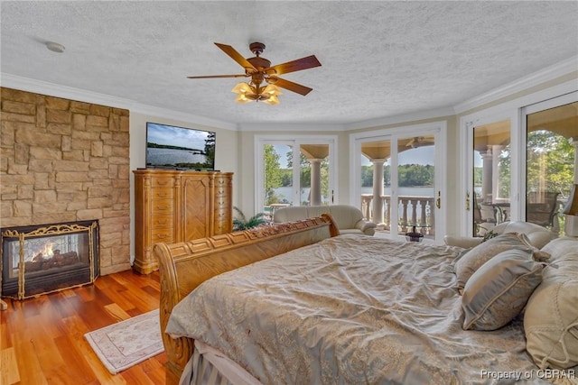 bedroom with ornamental molding, multiple windows, and access to exterior
