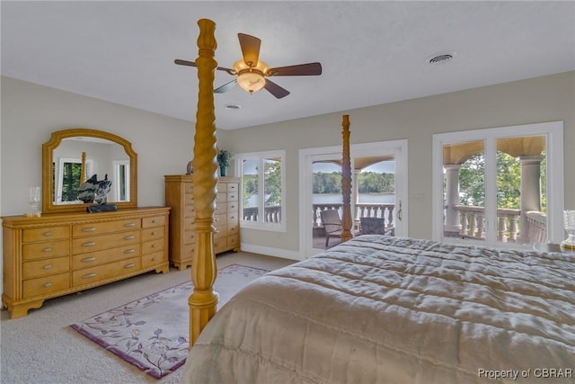 bedroom featuring access to outside, carpet floors, visible vents, and multiple windows