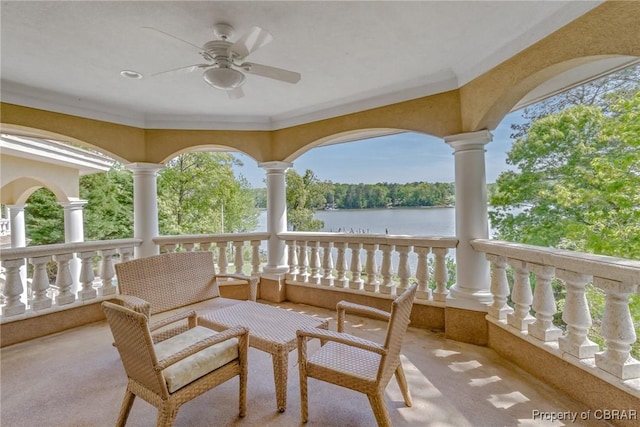 exterior space with a water view and a ceiling fan
