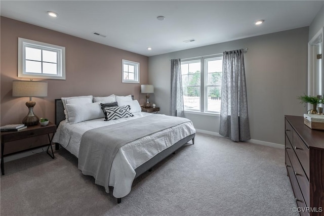 bedroom with visible vents, recessed lighting, baseboards, and light colored carpet