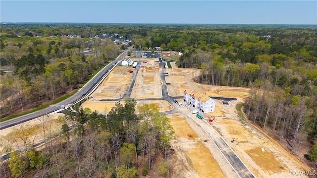 birds eye view of property featuring a wooded view