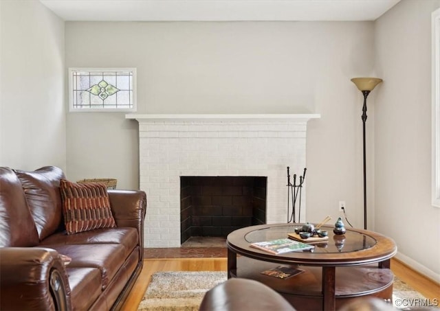 112 Webster Rd, Sandston, VA 23150 - living area featuring wood finished floors, a brick fireplace, and baseboards