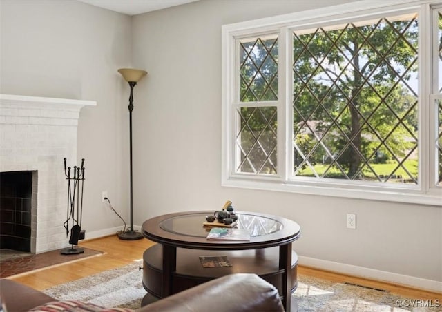 112 Webster Rd, Sandston, VA 23150 - living room featuring wood finished floors, baseboards, and a brick fireplace