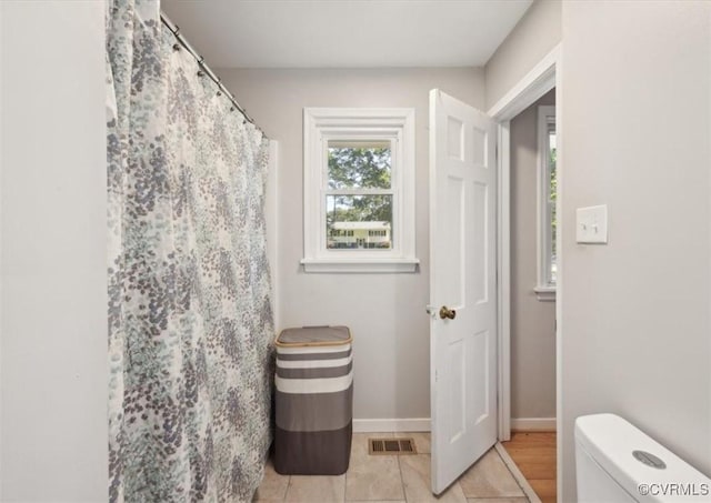 112 Webster Rd, Sandston, VA 23150 - bathroom with toilet, tile patterned flooring, baseboards, and a shower with shower curtain