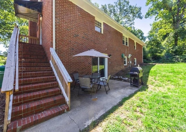 112 Webster Rd, Sandston, VA 23150 - view of side of home with stairway, brick siding, a patio, and a lawn