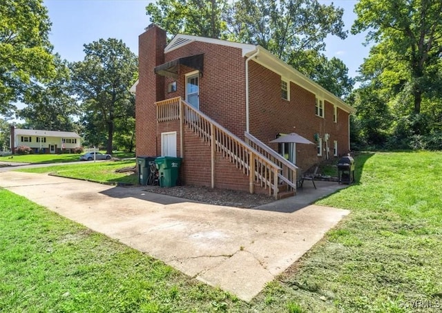 112 Webster Rd, Sandston, VA 23150 - view of side of property featuring brick siding, a chimney, a yard, and a patio area