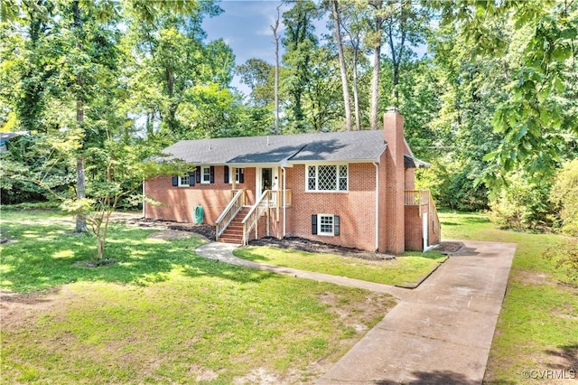 112 Webster Rd, Sandston, VA 23150 - view of front facade featuring a chimney, a front lawn, brick siding, and concrete driveway