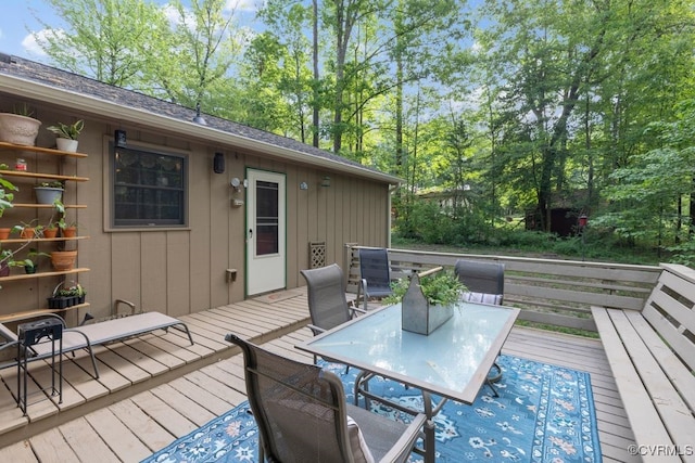 wooden terrace featuring outdoor dining area