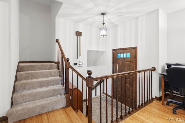 stairway with wood finished floors