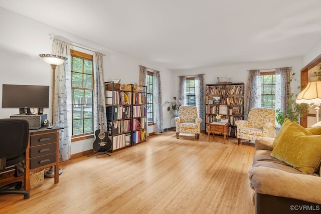 interior space with baseboards, plenty of natural light, and wood finished floors