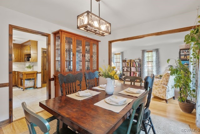 dining area with an inviting chandelier and light wood-type flooring
