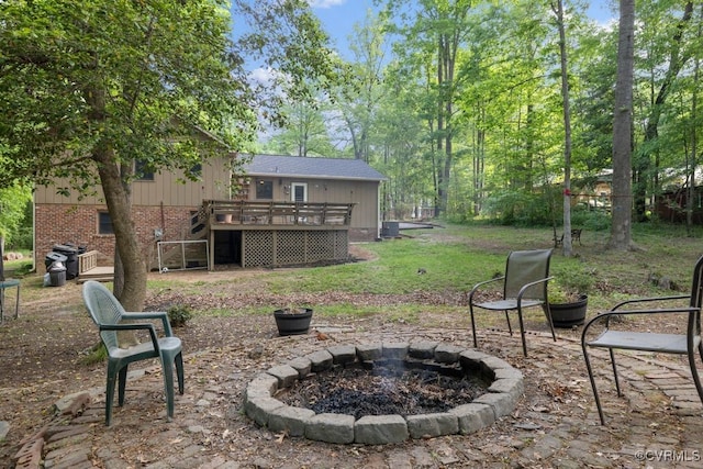 view of yard with stairway, a fire pit, and a deck