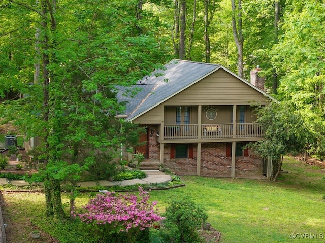 exterior space featuring a lawn, a chimney, and brick siding