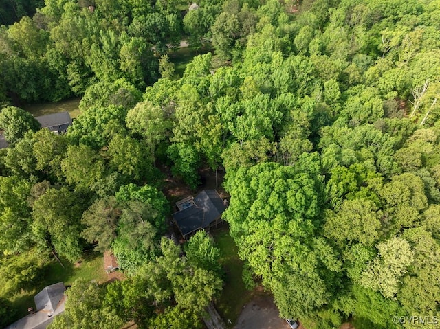 drone / aerial view with a wooded view