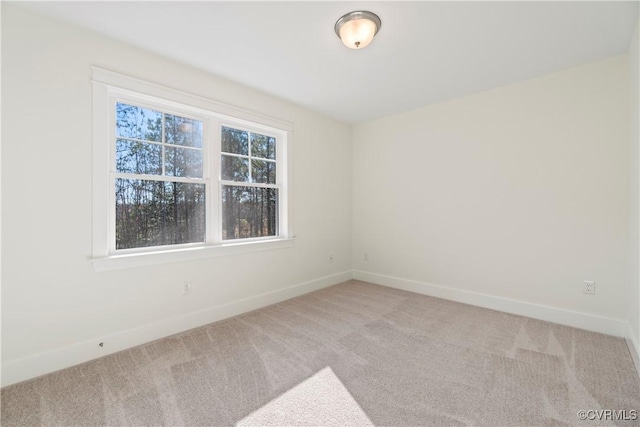unfurnished room featuring baseboards and carpet