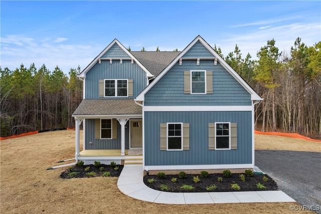 view of front of property featuring roof with shingles, covered porch, and board and batten siding