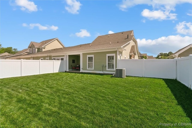 back of house with central air condition unit, a patio, a yard, and a fenced backyard