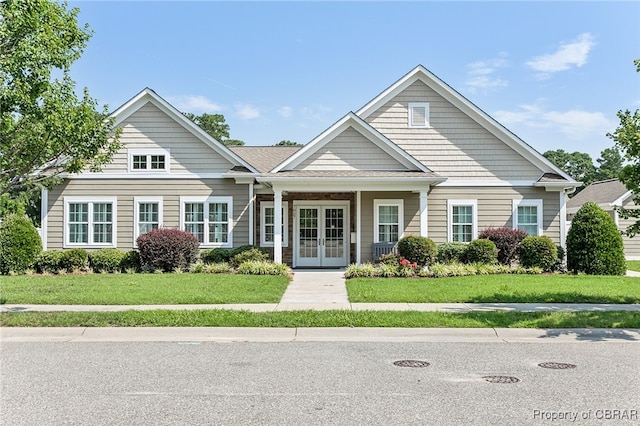 view of front of property with a front lawn and french doors