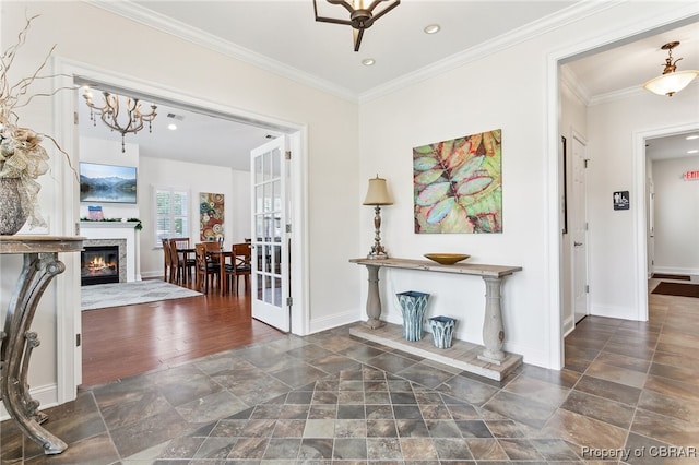 corridor featuring crown molding, baseboards, recessed lighting, and stone tile floors