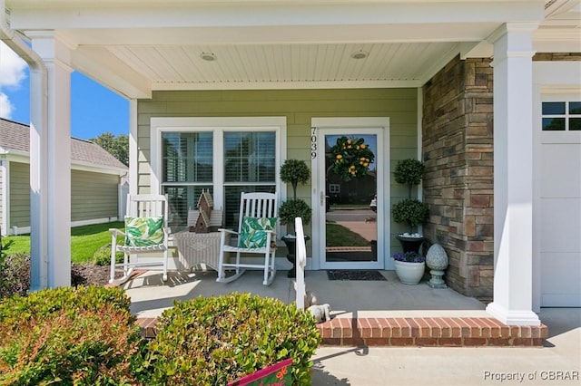 view of exterior entry with a porch
