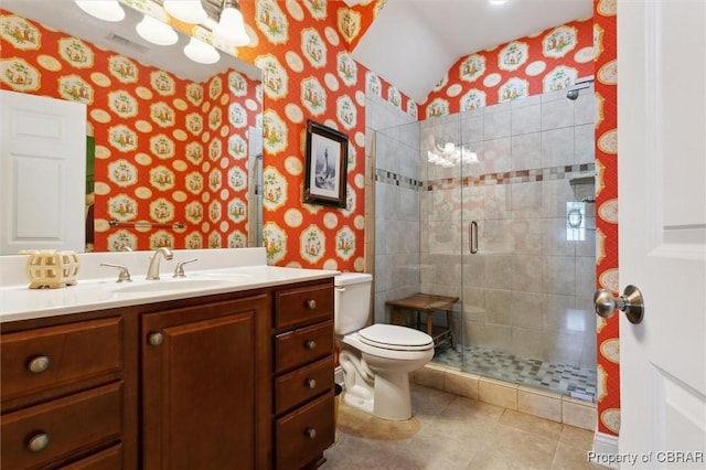 bathroom with vanity, toilet, wallpapered walls, and a stall shower