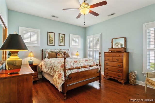bedroom with visible vents and multiple windows