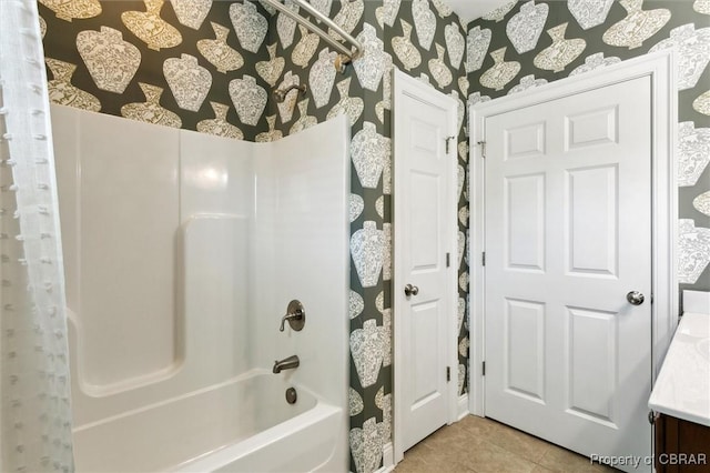 full bath with tile patterned floors, vanity, and shower / tub combination