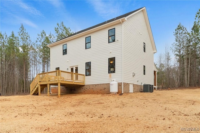 rear view of house featuring a wooden deck and stairway