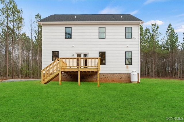 rear view of house featuring a yard, a deck, and stairway